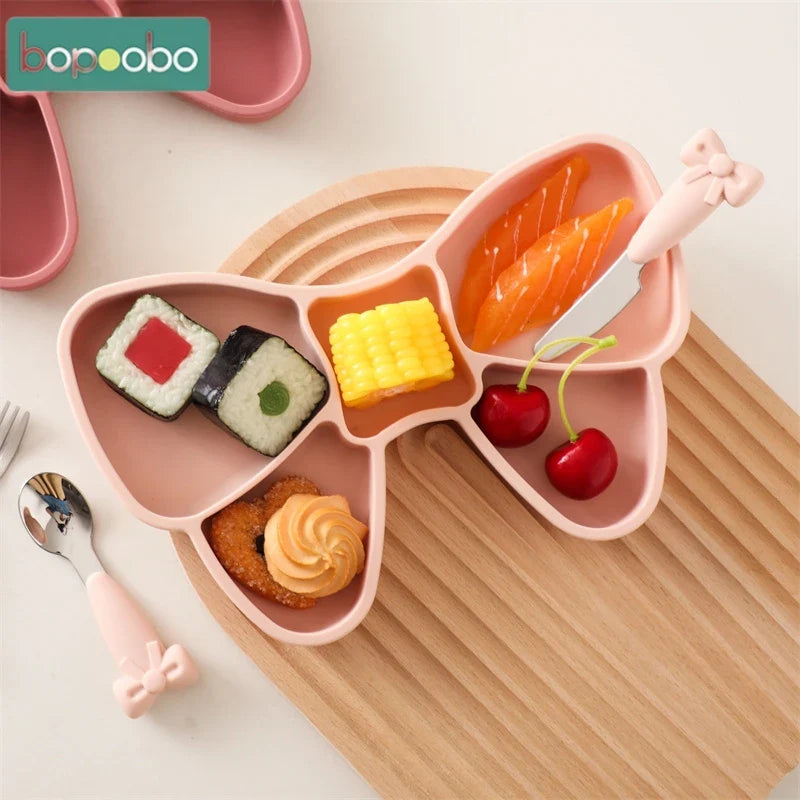 BPA-free silicone baby bowl in pastel blue with matching stainless steel toddler cutlery set, ideal for meals.