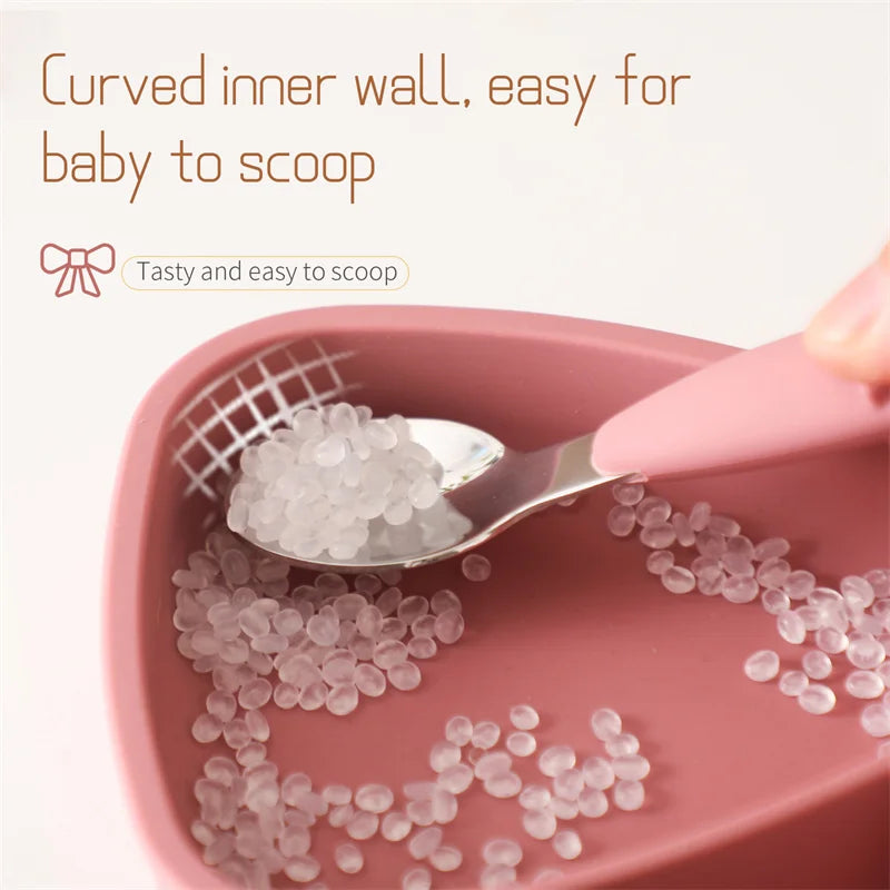 Toddler tableware set: soft silicone bowl, easy-grip stainless steel spoon & fork, promoting self-feeding.