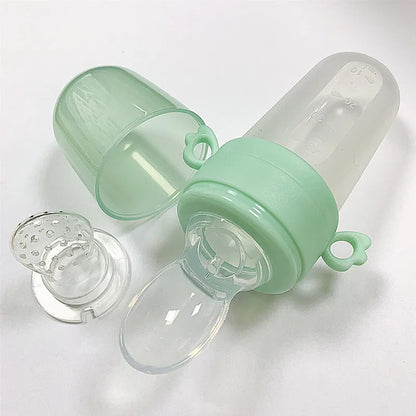Baby feeding set with soft-tip spoon and clear dropper, promoting independence