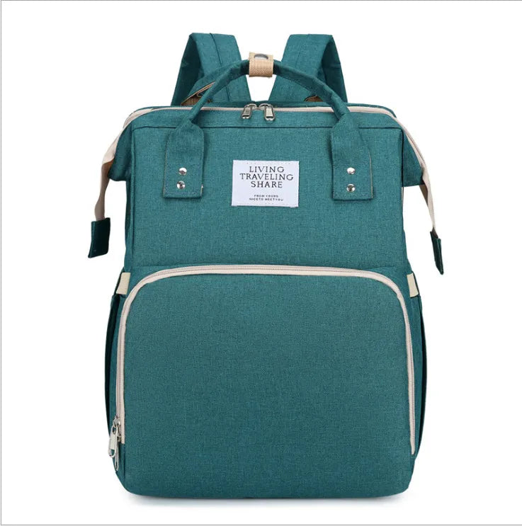 Gray baby backpack, folds into a crib, features USB charging capability and changing pad.