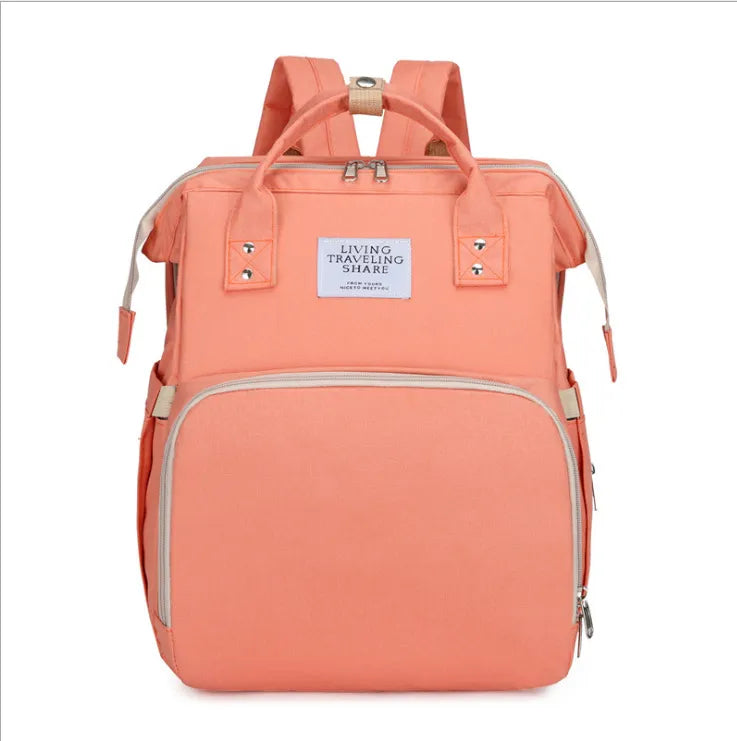 Essential baby travel bag: foldable crib backpack with USB port and detachable changing pad.