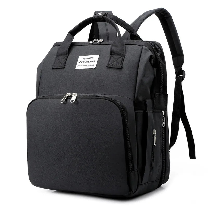 Stylish gray baby backpack with built-in foldable crib and convenient USB charging port.