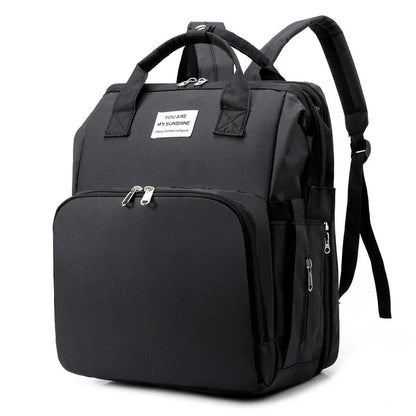 Stylish gray baby backpack with built-in foldable crib and convenient USB charging port.