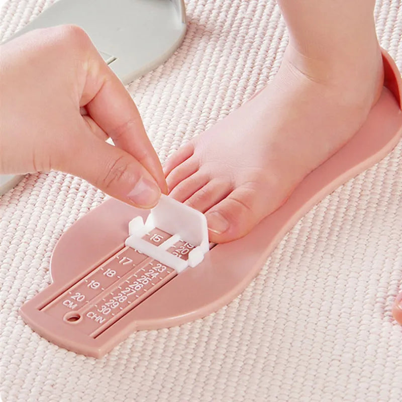 Baby Foot Measurement Gauge Tool in a parent's hand for infant shoe sizing