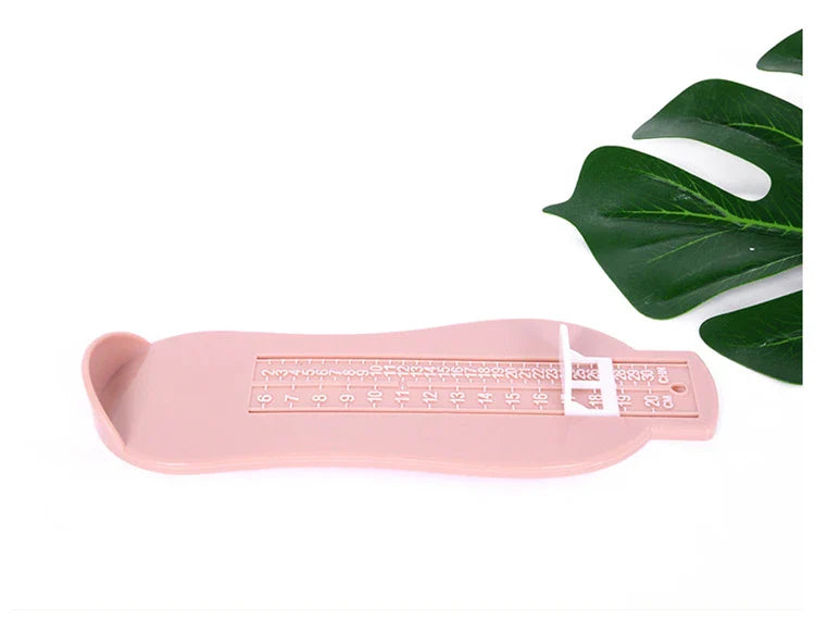 Multiple baby foot measurement gauge tools in various colors for comparison