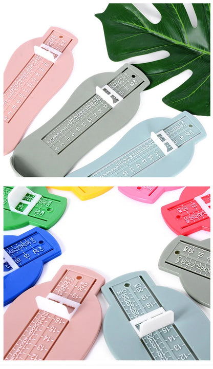 White plastic baby foot measurement gauge tool on a clean, light surface