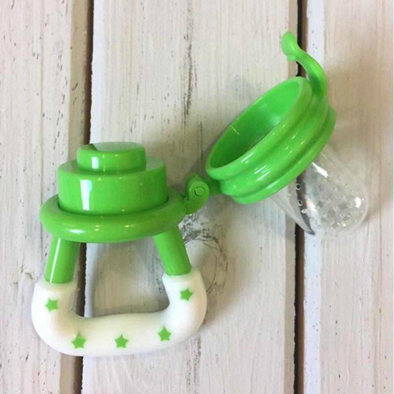 Happy baby using a yellow fruit feeder pacifier, enjoying new tastes and gentle gum massage.