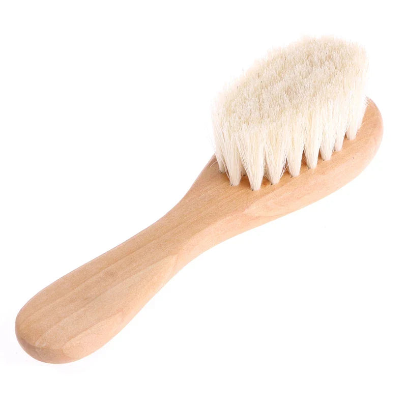 Baby bath time scene with bubbles and the Baby Gentle Scalp Massage Brush within reach.