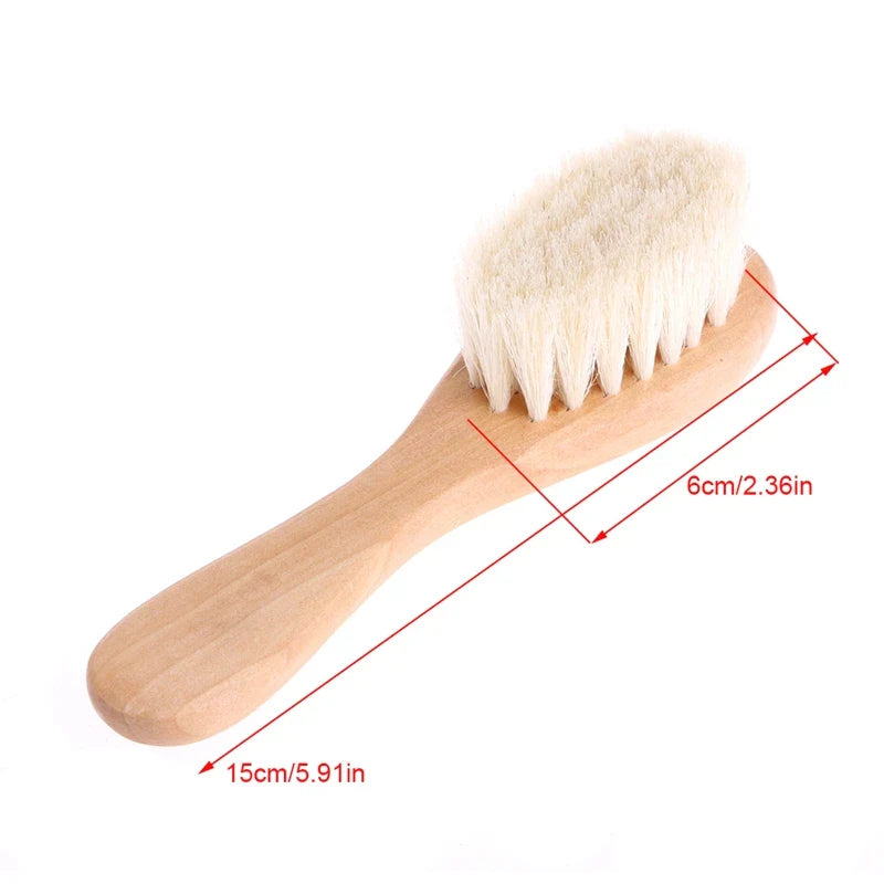 The Baby Gentle Scalp Massage Brush resting on a towel, ready for the next newborn bath.