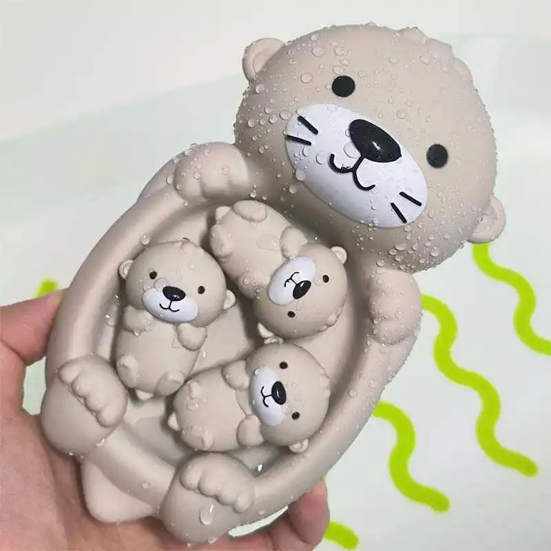Baby giraffe, elephant, lion, & pig silicone bath toys floating in water for sensory play