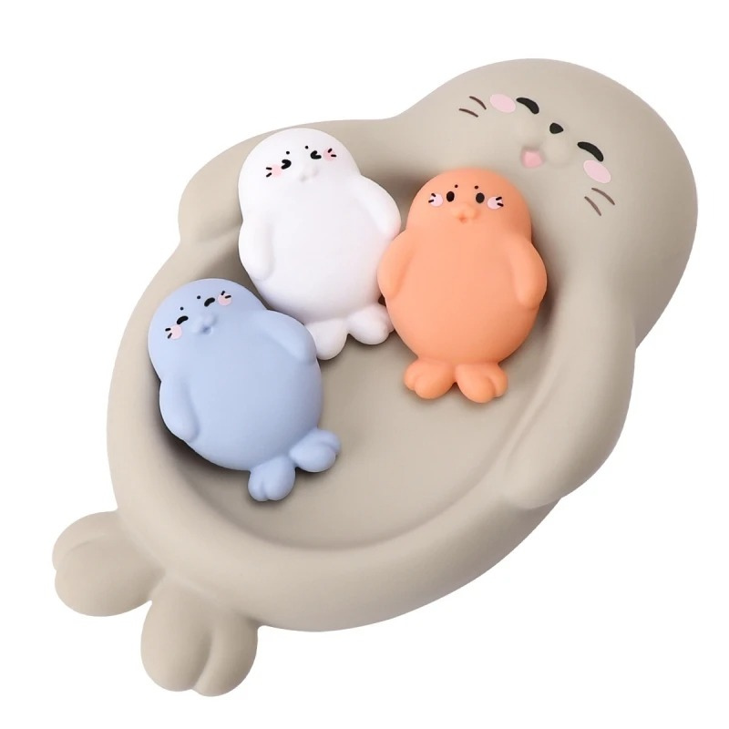 Toddler reaching for floating baby animal bath toys in different colors promoting sensory fun