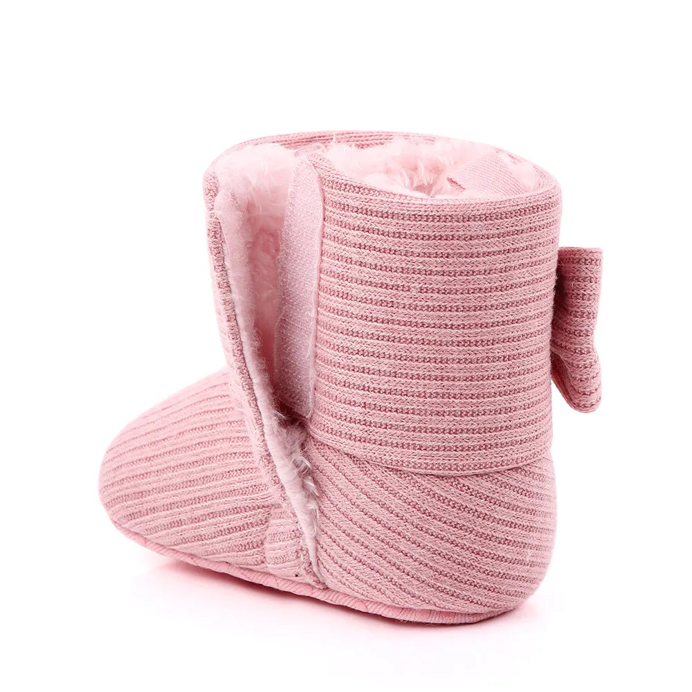 Display of baby girl's soft sole bowknot winter boots, essential infant footwear