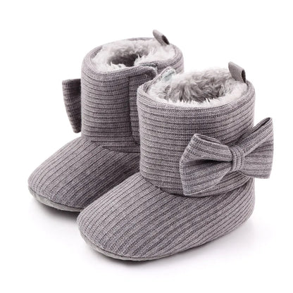 Pink baby girl's first walker boots with sweet bowknot, designed for cozy winter wear
