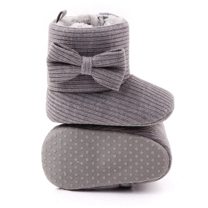 Studio shot of baby girl's cozy bowknot ankle boots, ideal for cold weather