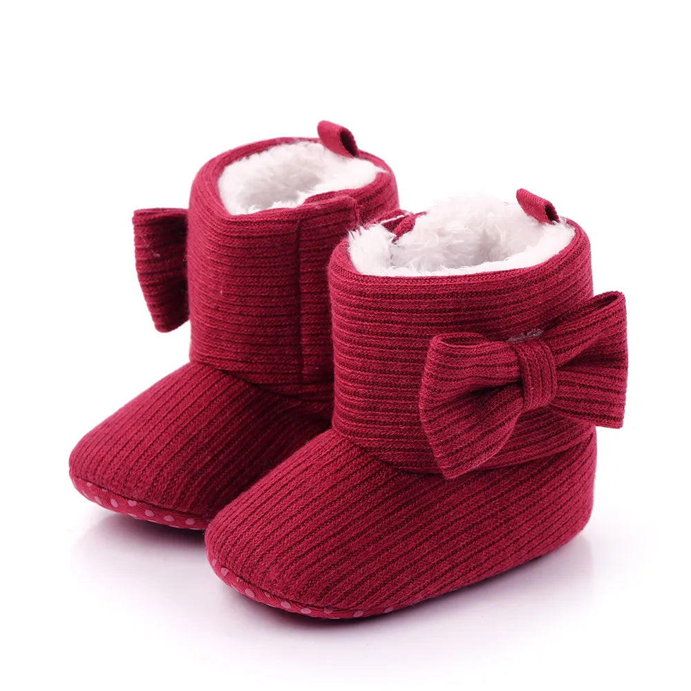 Collection of baby girl's cozy bowknot ankle boots in various pink shades, winter shoes