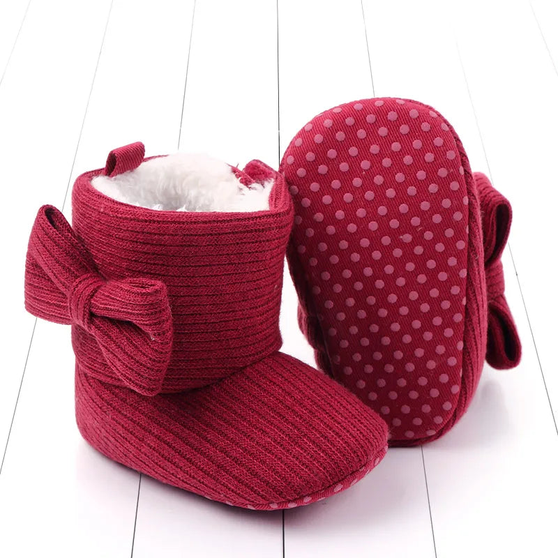 Pair of baby girl's warm knitted bowknot boots, ideal for cold weather, first walker
