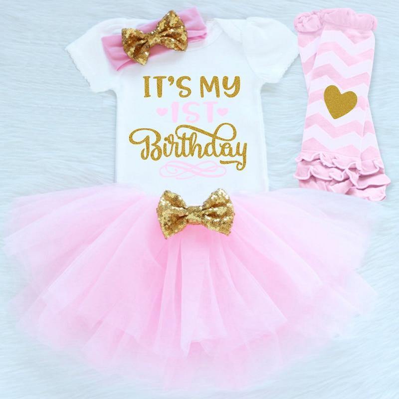 Toddler girl first birthday party outfit featuring a 'One' romper, pink tutu & leggings