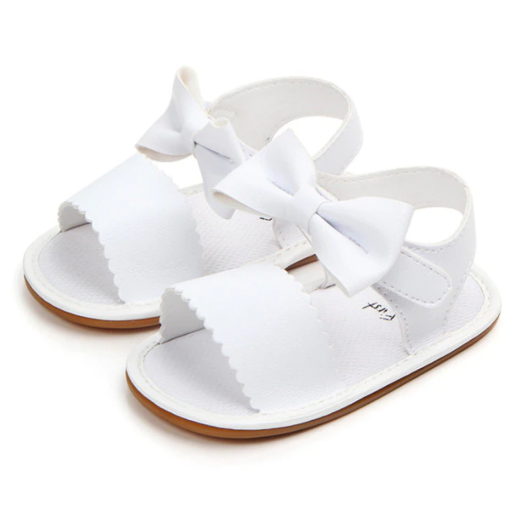 Close-up of baby girl soft sole first walker sandals with decorative bowknot