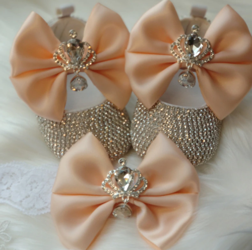 Baby girl's elegant beaded first walker shoes with a prominent bow, designed for support and style