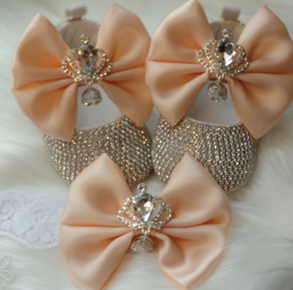 Baby girl's elegant beaded first walker shoes with a prominent bow, designed for support and style