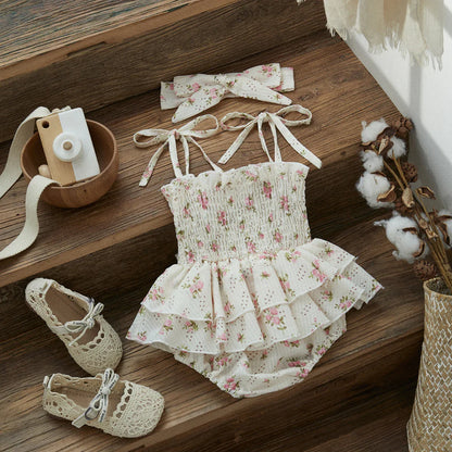 Close-up of a baby girl's floral ruffle romper with delicate ruffles and vibrant print, summer style