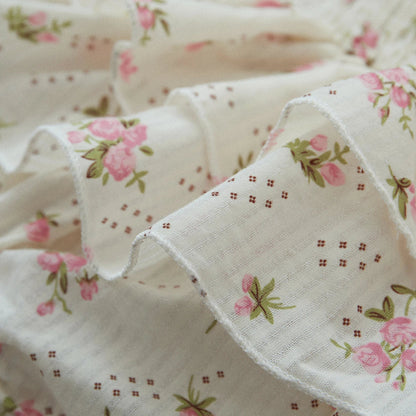Infant girl's summer outfit: sleeveless floral print romper with ruffles and a matching stretch headband