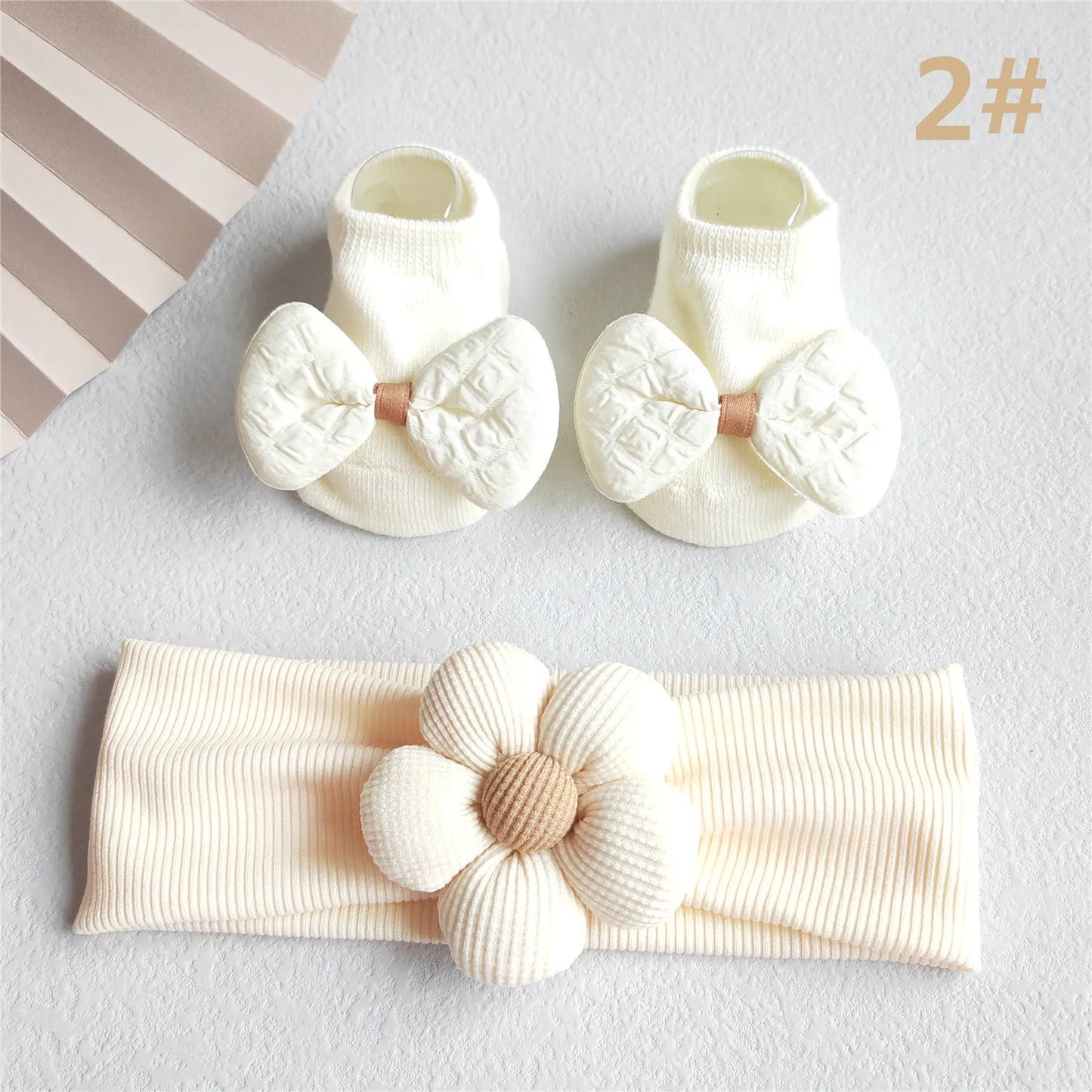 Close-up of the delicate lace and ribbon detailing on the baby girl's hair bow headband