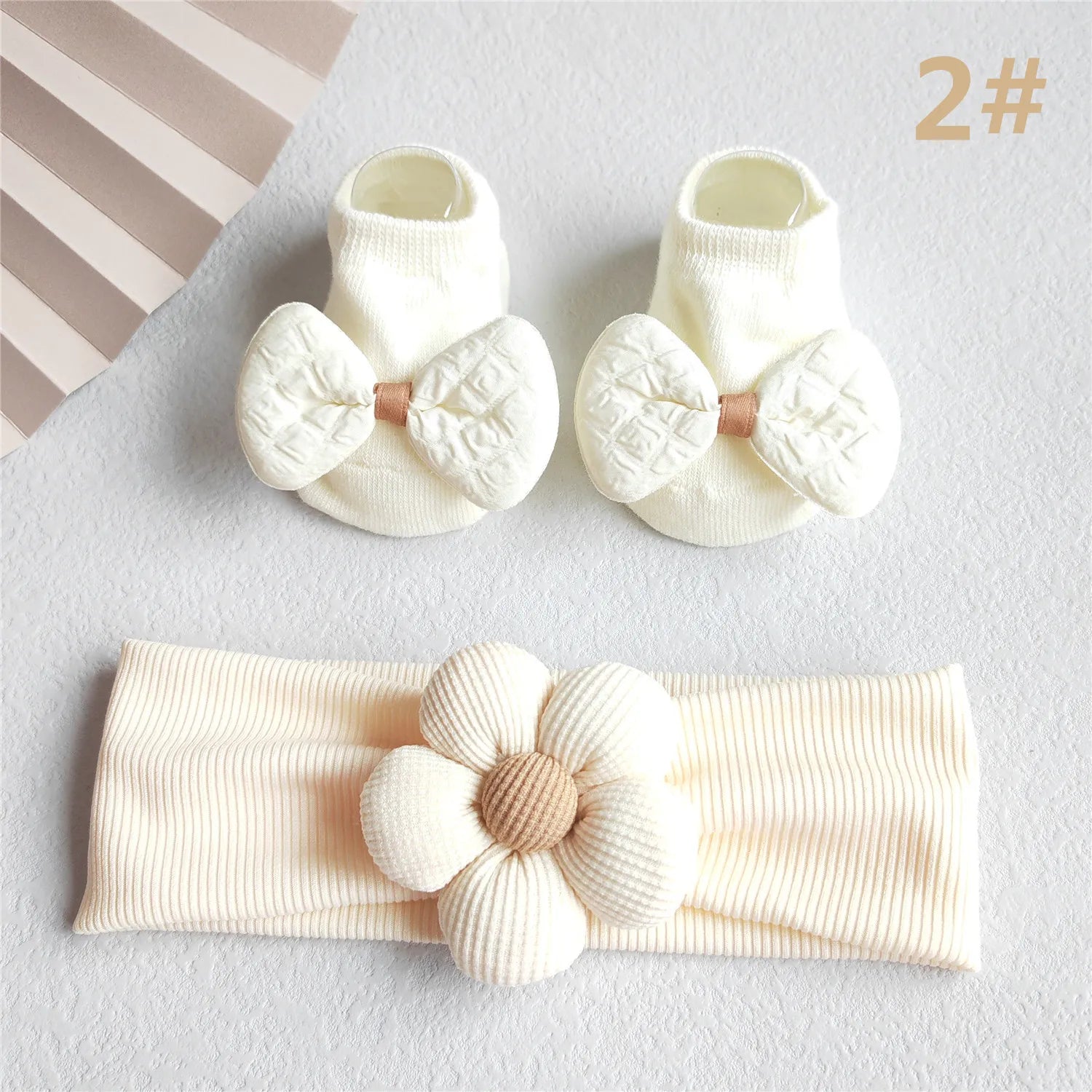 Close-up of the delicate lace and ribbon detailing on the baby girl's hair bow headband
