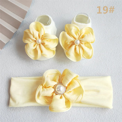 Elegant baby girl newborn set with a pretty lace bow headband and matching pink socks