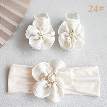 Princess style baby girl headband with intricate lace detail and a sweet pink bow