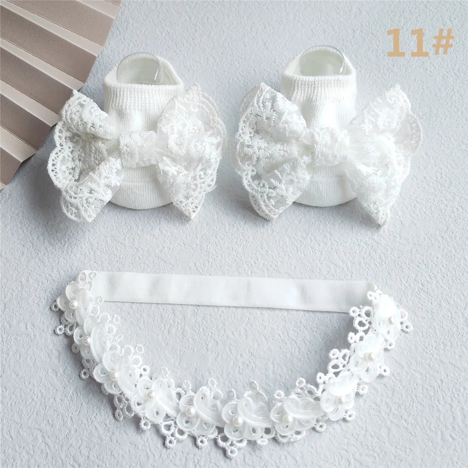 Newborn girl's gift: elegant lace bow headband paired with soft pink infant socks