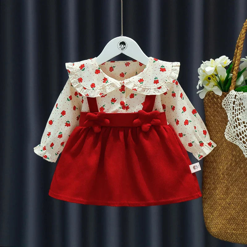 Detailed shot of the flower applique on an autumn floral strap dress for a baby girl, quality design.