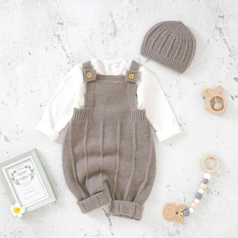 Baby girl in a pink knitted sleeveless romper and matching hat, perfect newborn outfit