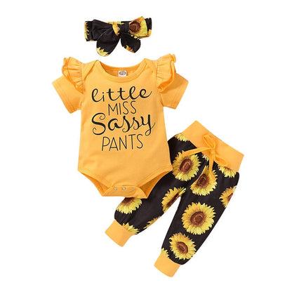 Adorable infant girl's cotton sunflower-print romper with snaps and a cute headwrap, ideal newborn gift.