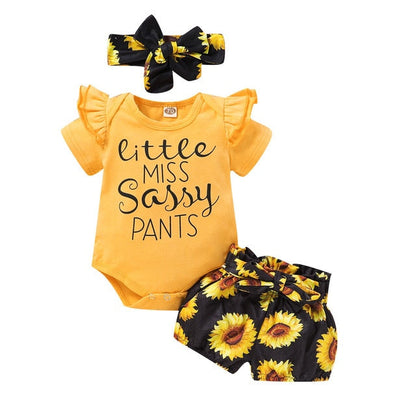 Close-up of a baby's sunflower short-sleeve romper and matching soft headband, a charming toddler outfit.