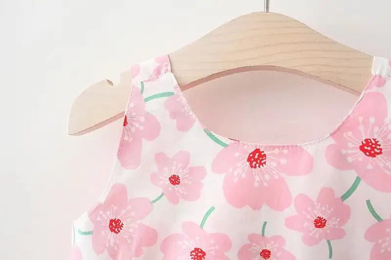 White floral summer dress with a charming pink bow, perfect for a baby girl's special occasion.