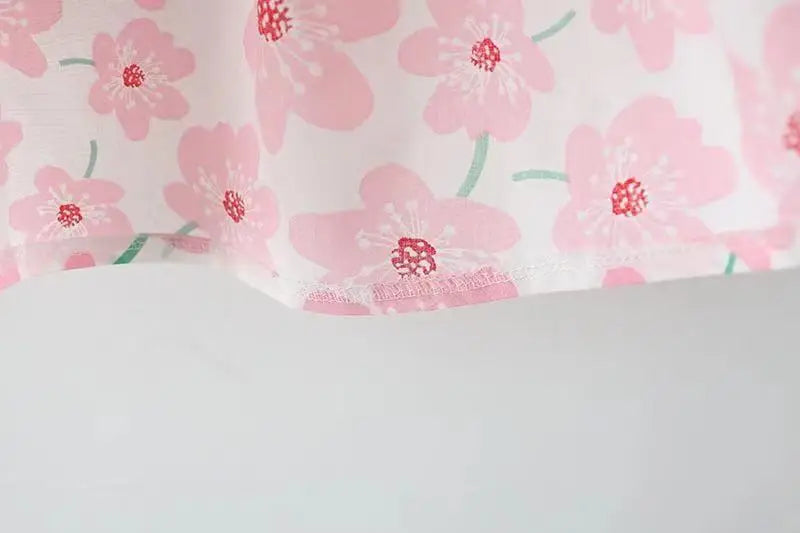 Top-down view of the sweet summer bow floral dress, showing its round neckline and full skirt.