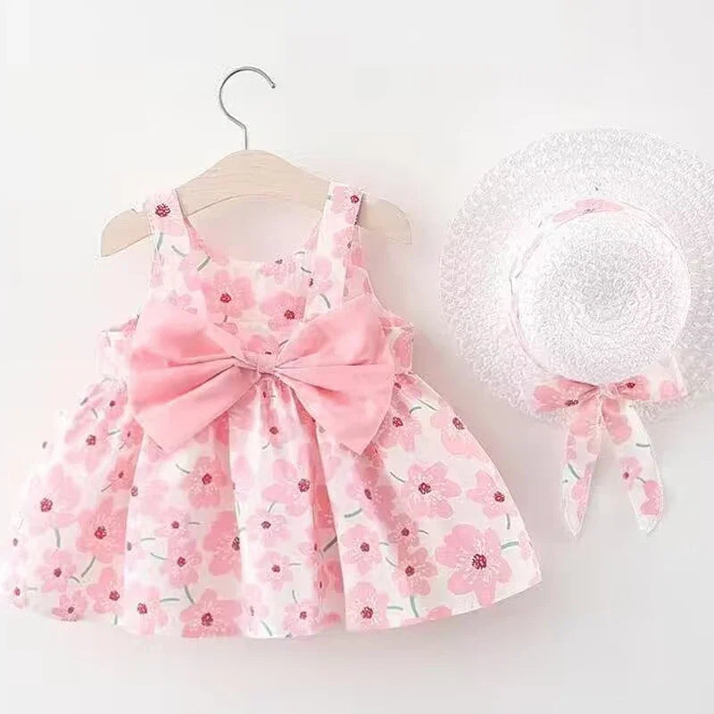 Close-up of a sweet summer floral bow dress for baby girls, featuring delicate pink flowers.