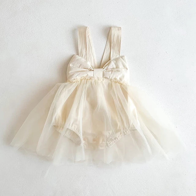 Baby girl in apricot cotton romper dress, perfect for summer comfort and infant fashion