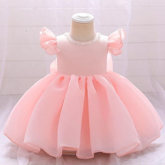 Baby girl in elegant pink beaded bow princess ball gown, perfect for special occasions, close-up.