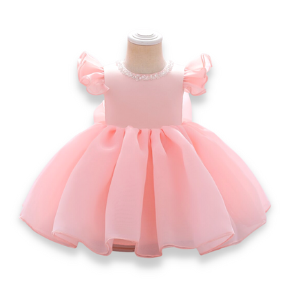 Infant formal wear: light blue ball gown with beaded neckline and big back bow, studio shot.
