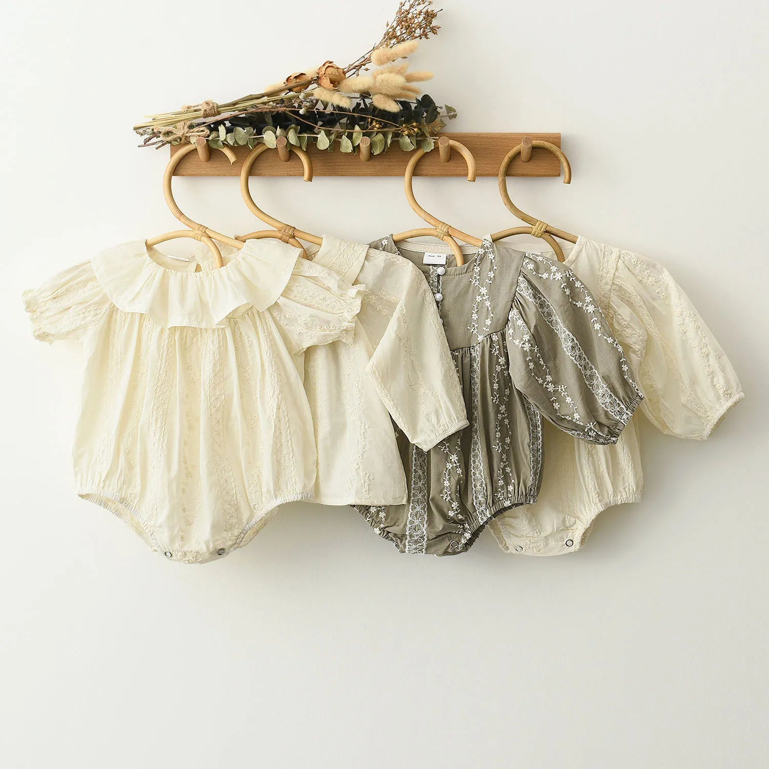 Baby girl in elegant white lace long sleeve romper, perfect for special occasions or daily wear.