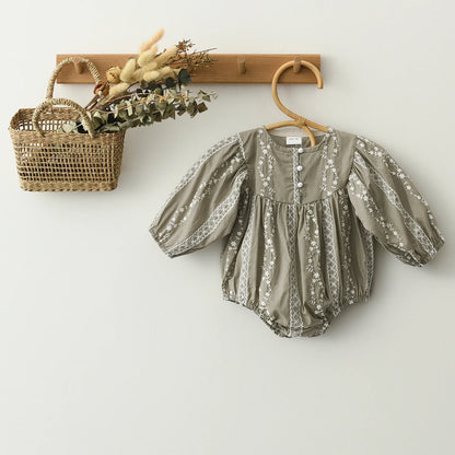Soft cotton baby romper with long sleeves and intricate lace, a comfortable and stylish newborn outfit.
