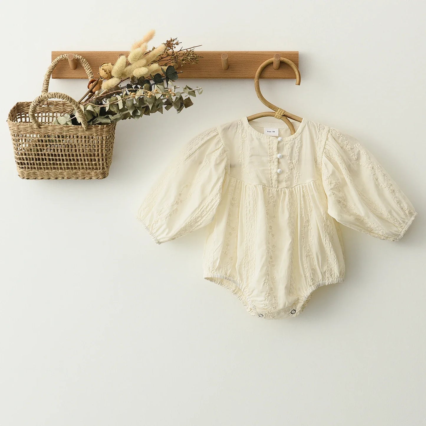 Elegant long sleeve lace romper for baby girls, featuring a comfortable design and premium cotton.