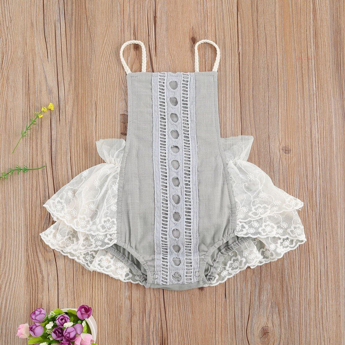 Baby girl in elegant white lace romper, short sleeves, for summer. Infant fashion.