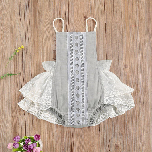 Baby girl in elegant white lace romper, short sleeves, for summer. Infant fashion.