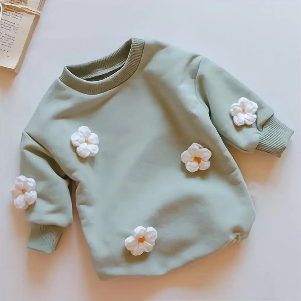 Close-up of floral pattern on baby girl's spring romper, soft fabric, ideal for newborns to 2T
