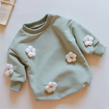 Close-up of floral pattern on baby girl's spring romper, soft fabric, ideal for newborns to 2T