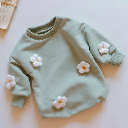 Newborn baby girl in a delicate floral print spring romper, softest cotton, gentle on skin