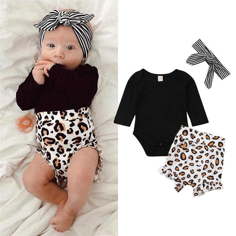 Baby girl in leopard print romper and matching shorts, soft cotton blend newborn outfit.